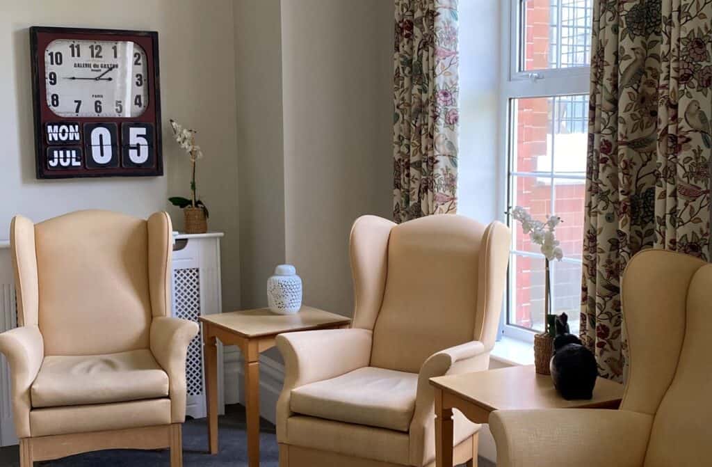 friendly residential care accommodation - Comfy chairs in corner of large lounge